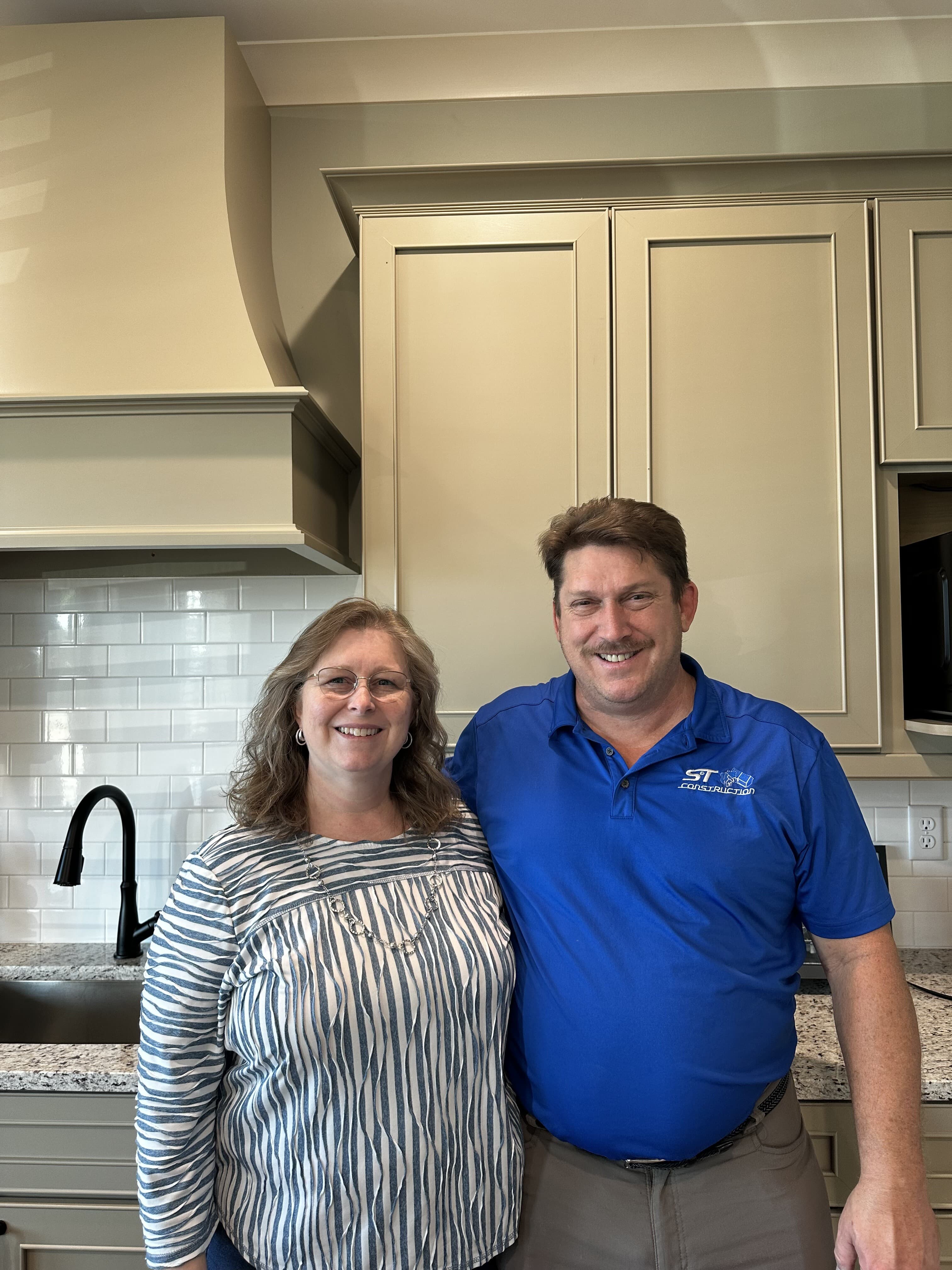 Scott and Tonya Conner, founders of S&T Construction, inside a finished custom home kitchen in Cookeville, Tennessee