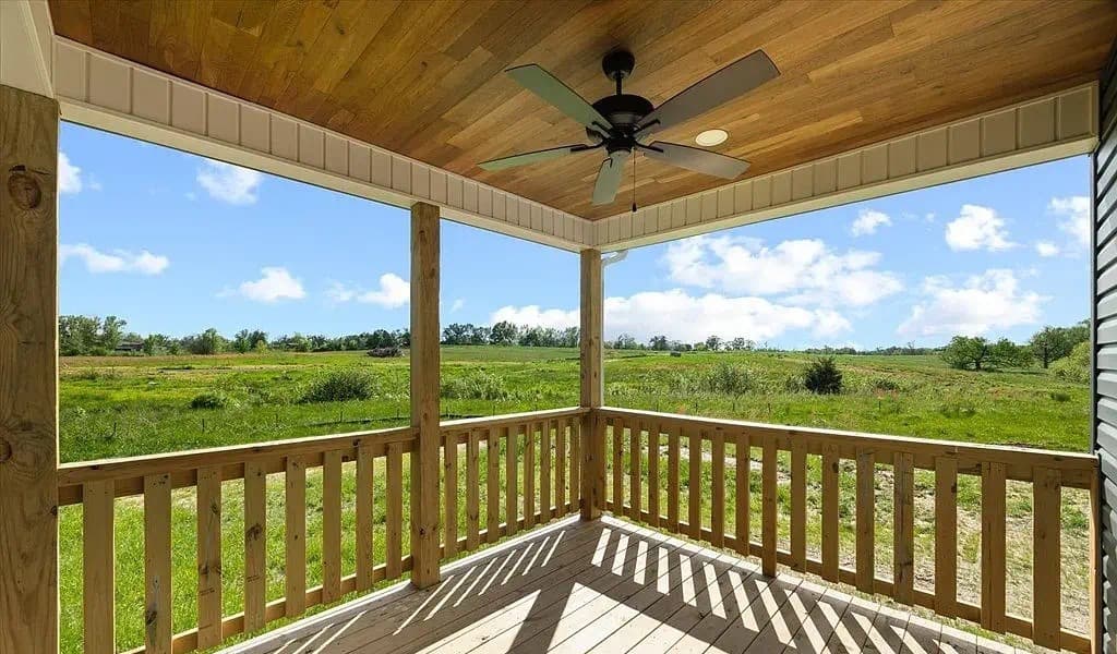 Covered back porch of The Kaley, an S&T Construction home, looking out over Tennessee farmland